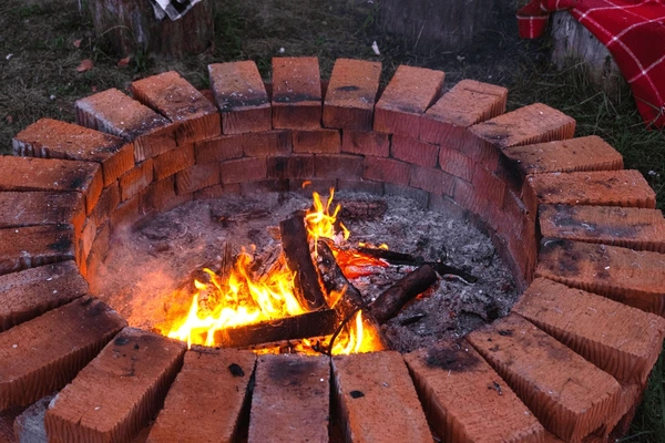 Oversized Red Brick Circular Fire Pit with Custom Stone Bench Seating