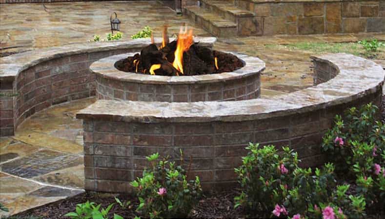 Red Brick Circular Fire Pit with Stone Seating Walls